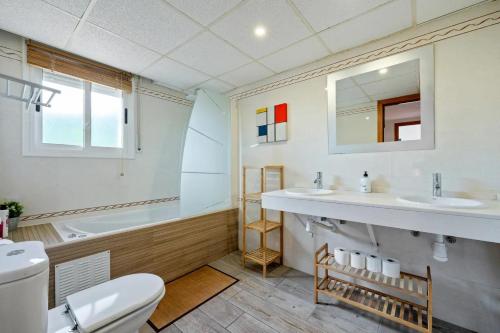 a bathroom with a toilet and a sink and a tub at Can Montclar - Preciosa casa cerca de Cambrils in Tarragona