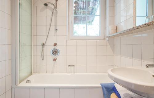 a bathroom with a tub and a sink at Amazing Apartment In Wagrain With House A Mountain View in Wagrain