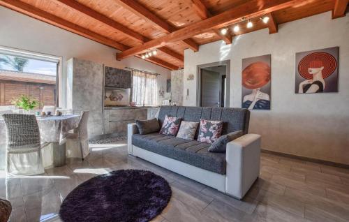 a living room with a couch and a table at 2 Bedroom Beautiful Home In Acireale in Acireale