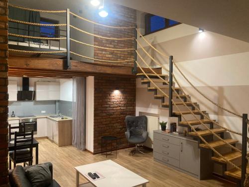 a loft with a spiral staircase in a room at A4 Luxury Apartment in Wrocław