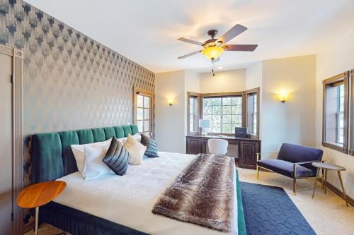 a bedroom with a large bed with a ceiling fan at The Chateau in Lake Arrowhead