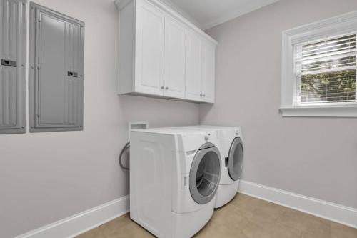 a white laundry room with a washing machine at 5 Bed 5 Bath Luxury Beach Front Home w/Ocean Views in Tybee Island