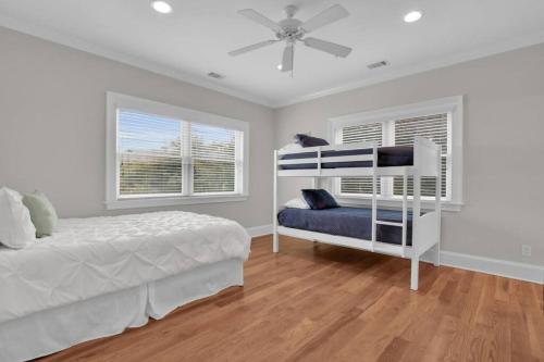 a bedroom with a bed and a ceiling fan at 5 Bed 5 Bath Luxury Beach Front Home w/Ocean Views in Tybee Island
