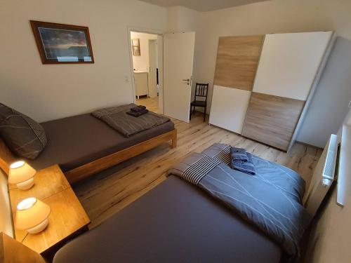 a small room with two beds and a table at Ferienwohnung am Rathaus in Landstuhl