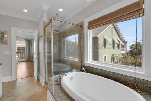 a bath tub in a bathroom with a large window at 5 Bed 5 Bath Luxury Beach Front Home w/Ocean Views in Tybee Island