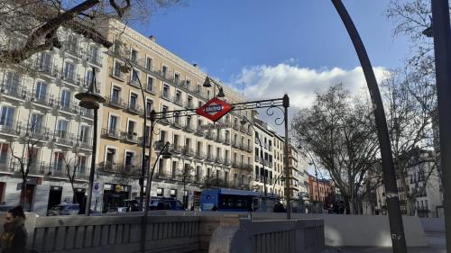 a street with buildings and a sign on a pole at HOSTAL DANIEL in Madrid