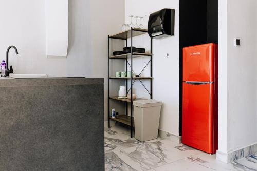 a red refrigerator in a kitchen next to a shelf at Allegra House in Zagreb