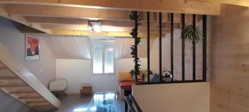 Habitación con escalera, ventana y mesa. en Lamatacam 9.1 Armoise Duplex 2 chambres en Argelès-Gazost
