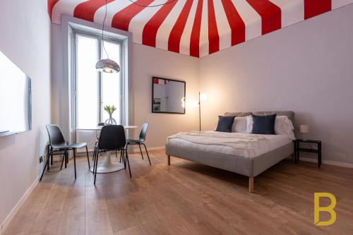 a bedroom with a bed and a red and white ceiling at BePlace Apartments in Chinatown in Milan