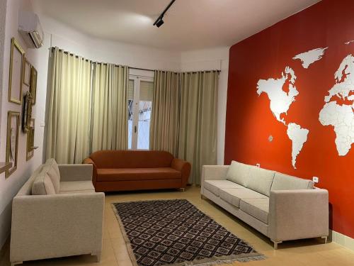 a living room with a couch and a world map on the wall at Nomads Hostel Tunisia in Tunis