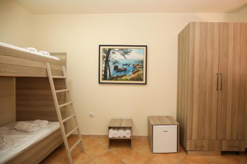 a bedroom with a bunk bed and a ladder at Blue Bay Residence in Vlorë