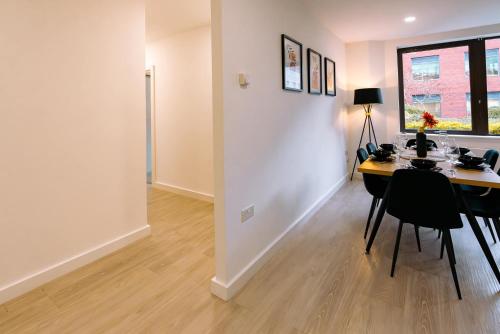 a dining room with a table and chairs and a window at Modern City Centre Apartment in Exeter