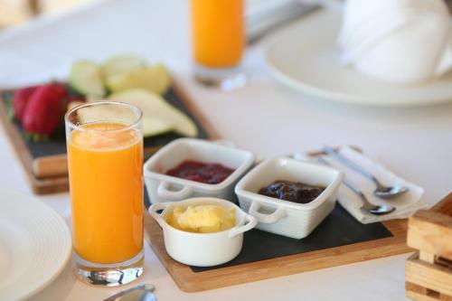 a tray with a glass of orange juice and some food at Blue Bay Residence in Vlorë