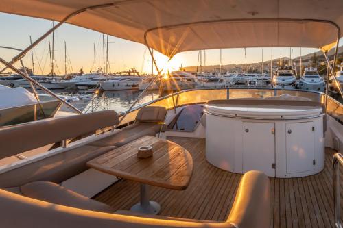 a boat with a wooden table on the deck at Luxury Yacht "Amato" in Sanremo