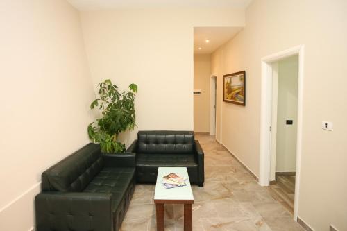 a living room with a couch and a table at Blue Bay Residence in Vlorë