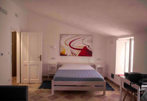 a bedroom with a bed and a painting on the wall at Pocco Andante in Dubrovnik