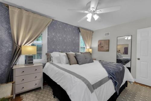 a bedroom with a bed and a ceiling fan at Mayfair Hideaway: 3 Bed 2 Bath Savannah BnB in Savannah