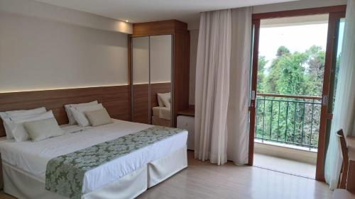 En eller flere senge i et værelse på Vista Azul Apartamento - hospedagem nas montanhas