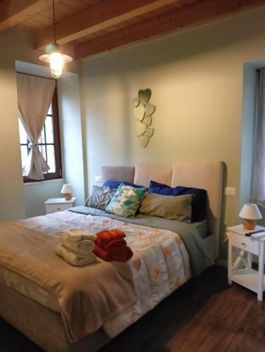 a bedroom with a large bed with towels on it at Little Family in Salò