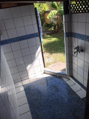 an open door to a shower in a bathroom at My Island Home in Fare