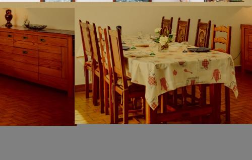 a dining room table with a white table cloth at Holiday Home Kerguigniou in Kermeur