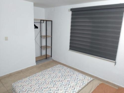 a room with a window with a mattress in front of it at Depa Eco en planta baja, a 5 minutos del malecon y zona dorada in Mazatlán