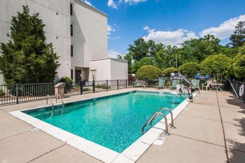a swimming pool with a slide in front of a building at Travel Inn-Flowood in Flowood