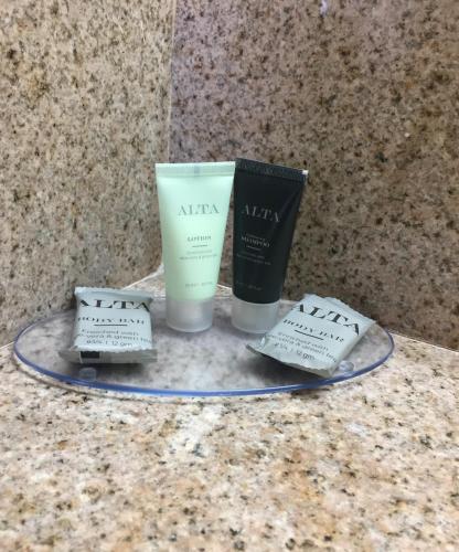 a tray with two candles and a book on a counter at Americas Best Value Inn-Near NRG Park/Medical Center in Houston