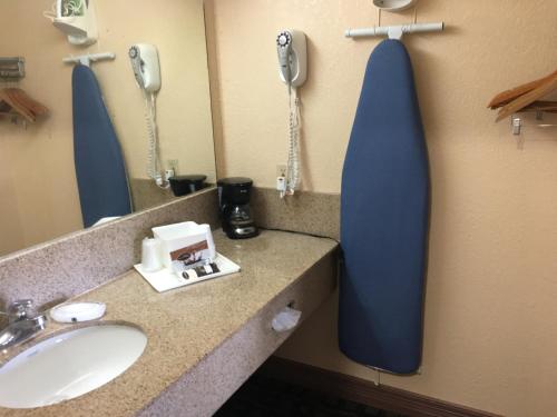 a bathroom with a sink and a phone on the wall at Americas Best Value Inn-Near NRG Park/Medical Center in Houston