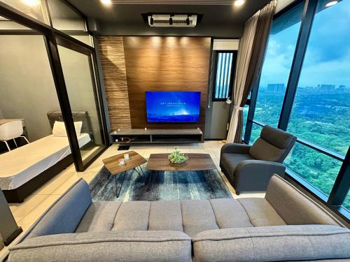 a living room with a couch and a tv at Suite Opus Kuala Lumpur in Kuala Lumpur