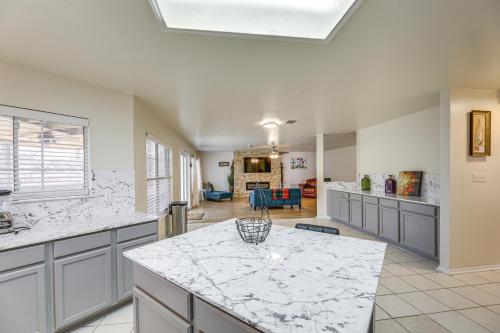a large kitchen with a white counter top at Austin Home with Deck - 9 Mi to Zilker Park! in Austin