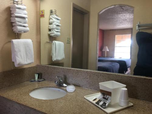 a hotel bathroom with a sink and a mirror at Americas Best Value Inn-Near NRG Park/Medical Center in Houston