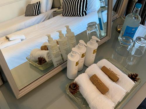 a bathroom with towels and bottles on a table at Number 10 Bed & Breakfast in Keswick