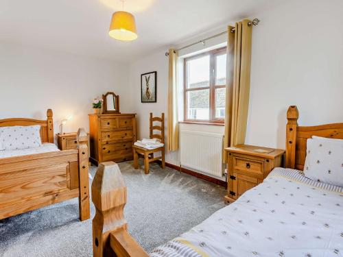 a bedroom with two beds and a window at 2 Bed in Bude 51764 in Pyworthy