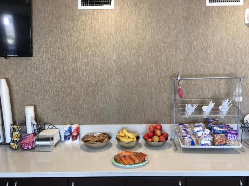 a kitchen counter with bowls of food and fruits at Americas Best Value Inn-Near NRG Park/Medical Center in Houston