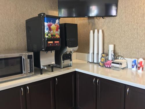 a kitchen counter with a microwave and a coffee maker at Americas Best Value Inn-Near NRG Park/Medical Center in Houston