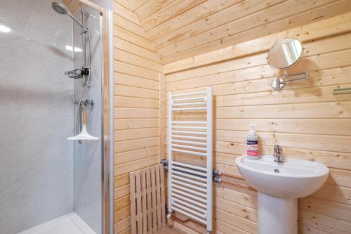 a bathroom with a toilet and a sink and a shower at Cairngorm Bothies in Aboyne