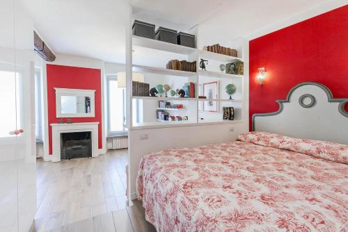 a red bedroom with a bed and a fireplace at Charming and elegant apartment historic center of Milan in Milan