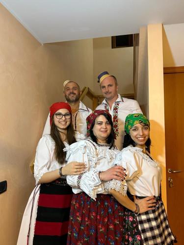 a group of people in traditional dress posing for a picture at GIADDA Rooms in Borşa