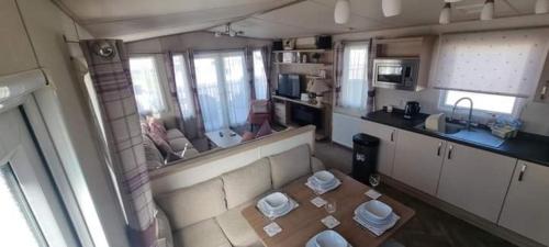 an overhead view of a kitchen with a table in a room at Seasalter Cosy Caravan, in Seasalter
