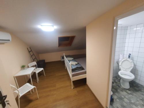 a small room with a bed and a toilet at Kapana Stay at Center Plovdiv in Plovdiv