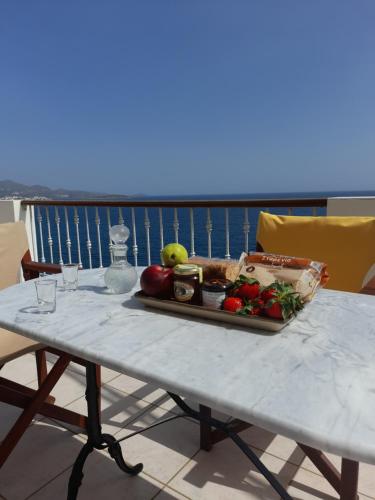 a tray of fruits and vegetables on a table at Mirabello Sea House in Agios Nikolaos