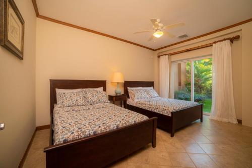 a bedroom with two beds and a window at Los Suenos Veranda 3G by Stay in CR in Herradura