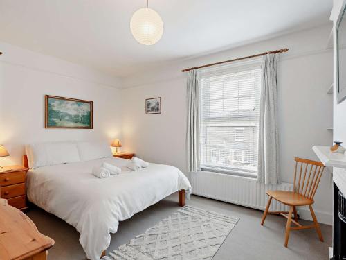 a bedroom with a white bed and a window at 3 Bed in Arundel 90894 in Arundel