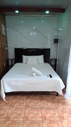 a bed with two white towels on top of it at HOTEL, VILLAS y GLAMPINGS MYA -PUERTO VIEJO, Limon, CR in Puerto Viejo