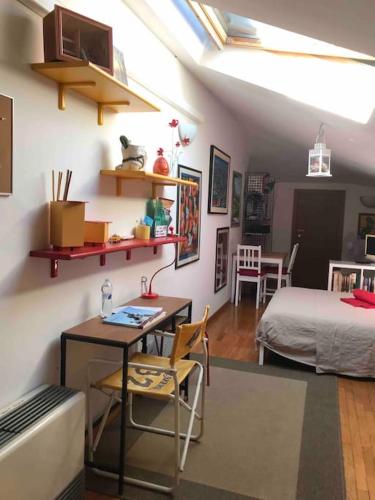 a room with a desk and a bed and a bedroom at Monolocale A Modo Mio B&B in Bologna