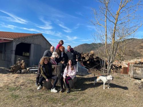 a group of people posing for a picture with a dog at Allotjaments rurals Can Punti in Vallfogona de Ripolles