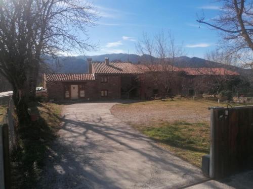 a house with a driveway in front of it at Allotjaments rurals Can Punti in Vallfogona de Ripolles