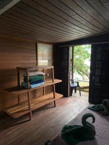 a room with a cabin with a wooden floor at Pousada D'Aconchego Nova Brasilia in Ilha do Mel
