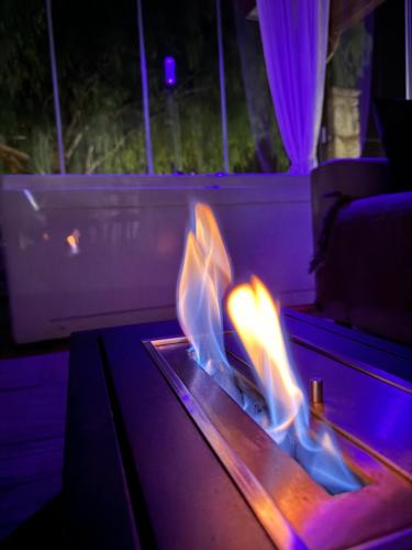 a fire in a table in a room at Green Oasis Gabella in Castelforte